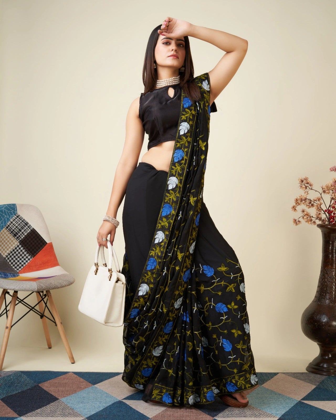 Black Kashmiri Work Saree – styled with handbag side view – KS398