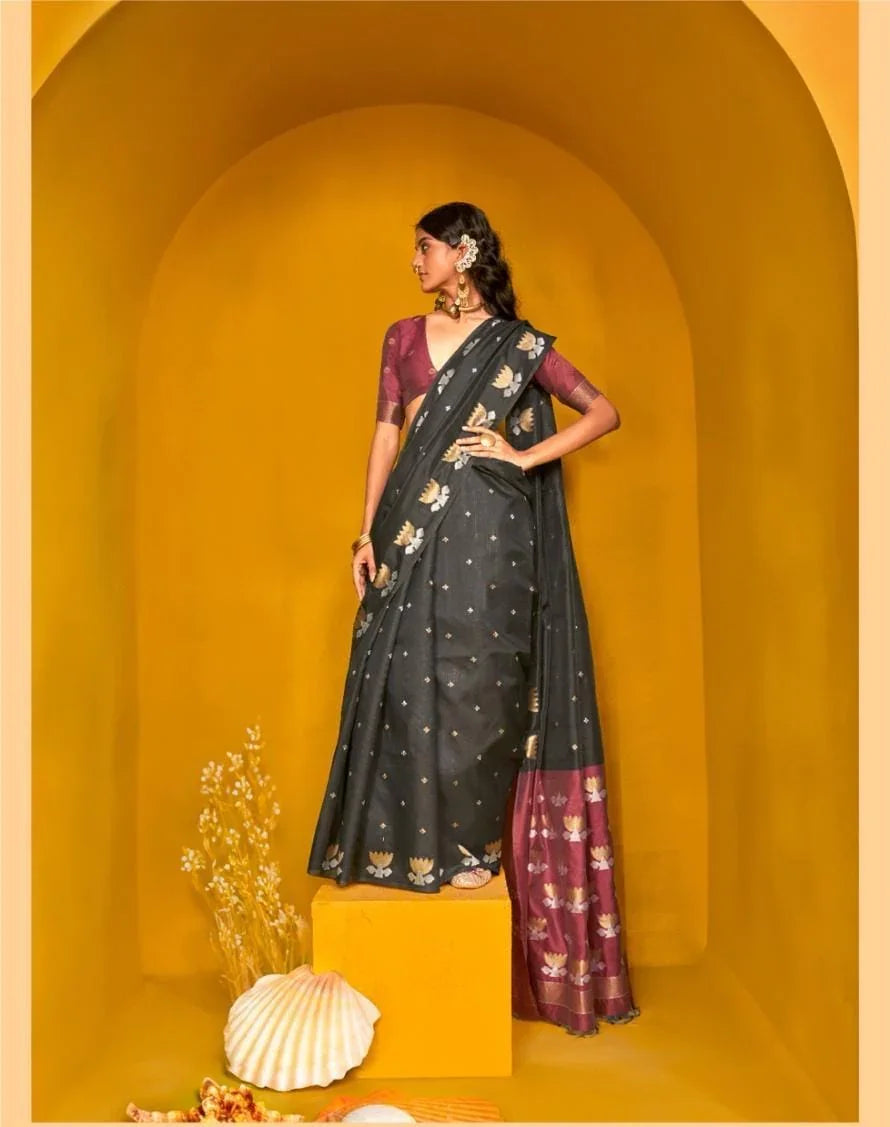 Woman in black saree with intricate zari work design