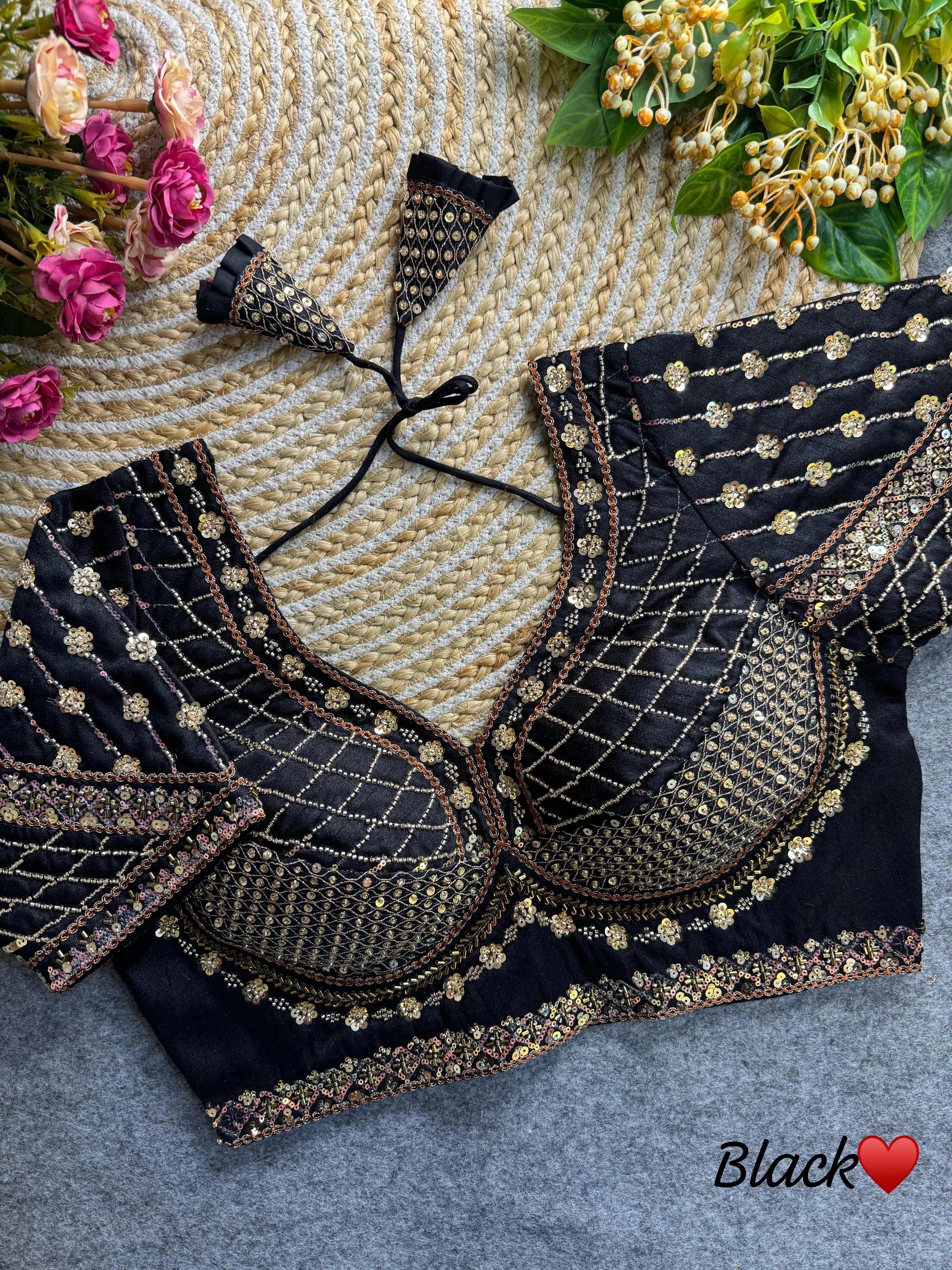 Black blouse featuring intricate sequence and codding thread work on soft silk fabric.