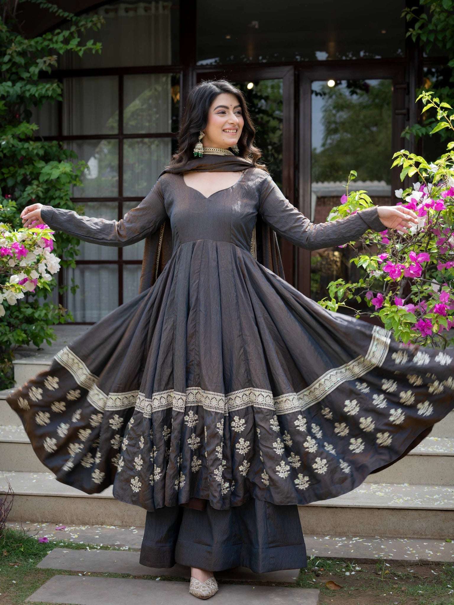 Black Anarkali Suit arms spread showing dramatic flair with floral booti border