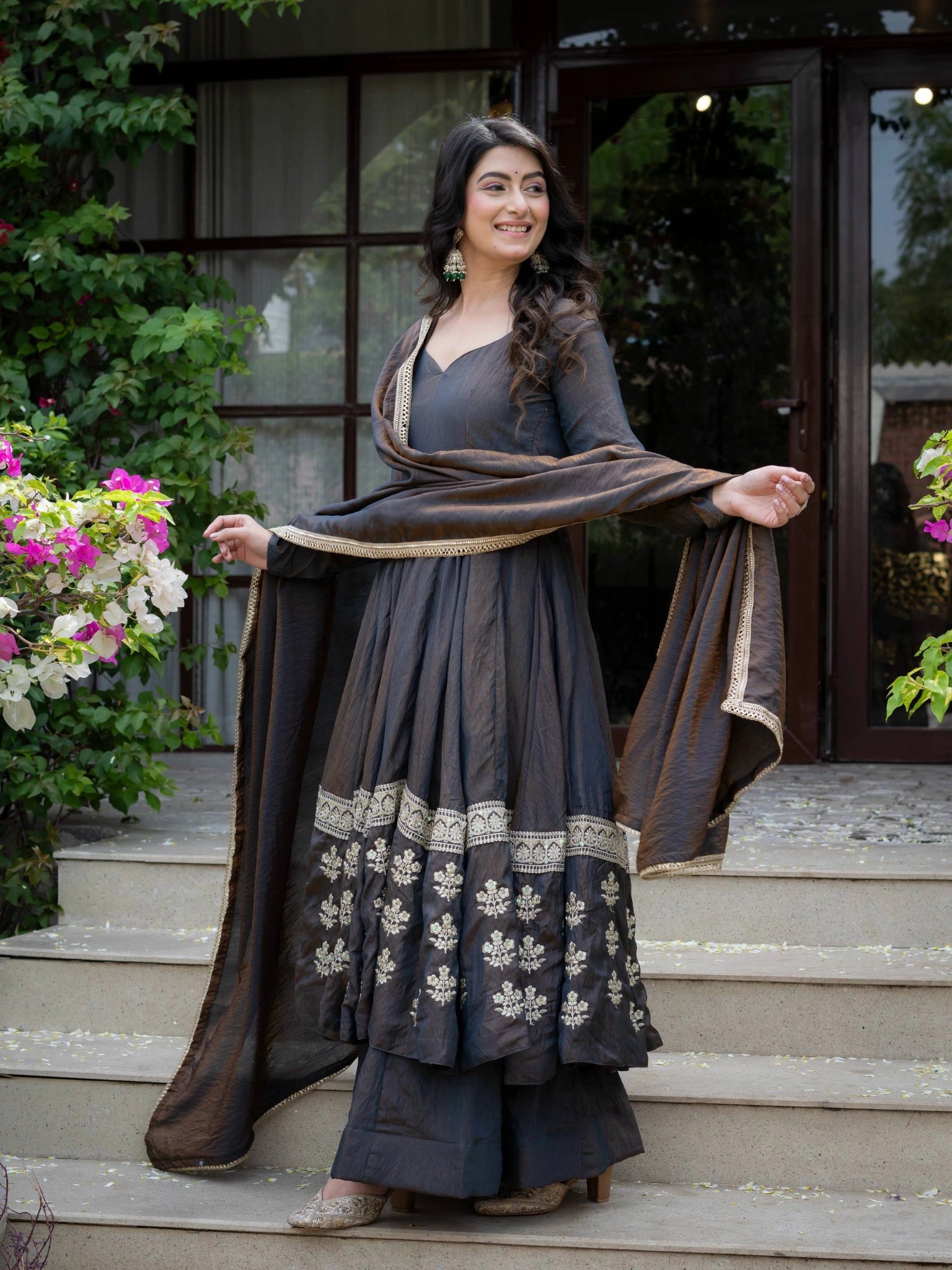 Black Sequins Anarkali Suit three quarter side view model holding dupatta