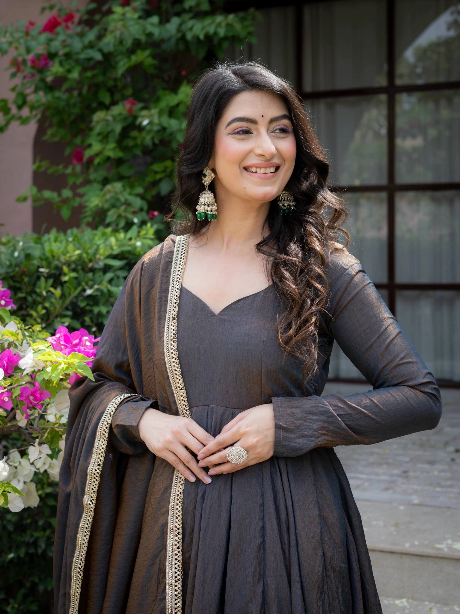 Black Anarkali Suit close up portrait showing V neckline and gold earrings