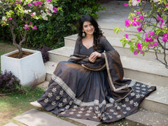 Black Sequins Anarkali Suit model seated on garden steps lifestyle shot