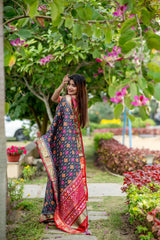 Woman wearing a blue saree with intricate zari work, showcasing traditional elegance in an outdoor setting