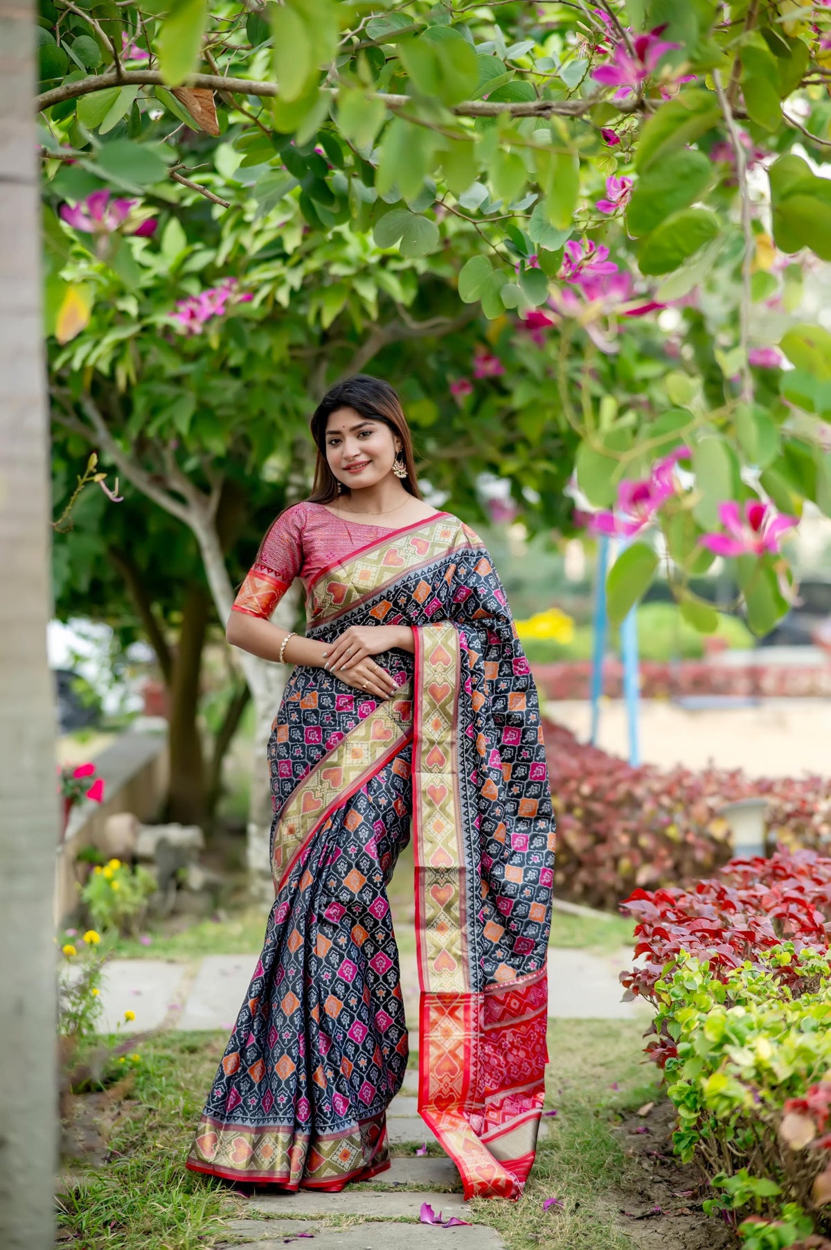 Woman wearing a blue saree with intricate zari work, showcasing a traditional ethnic look