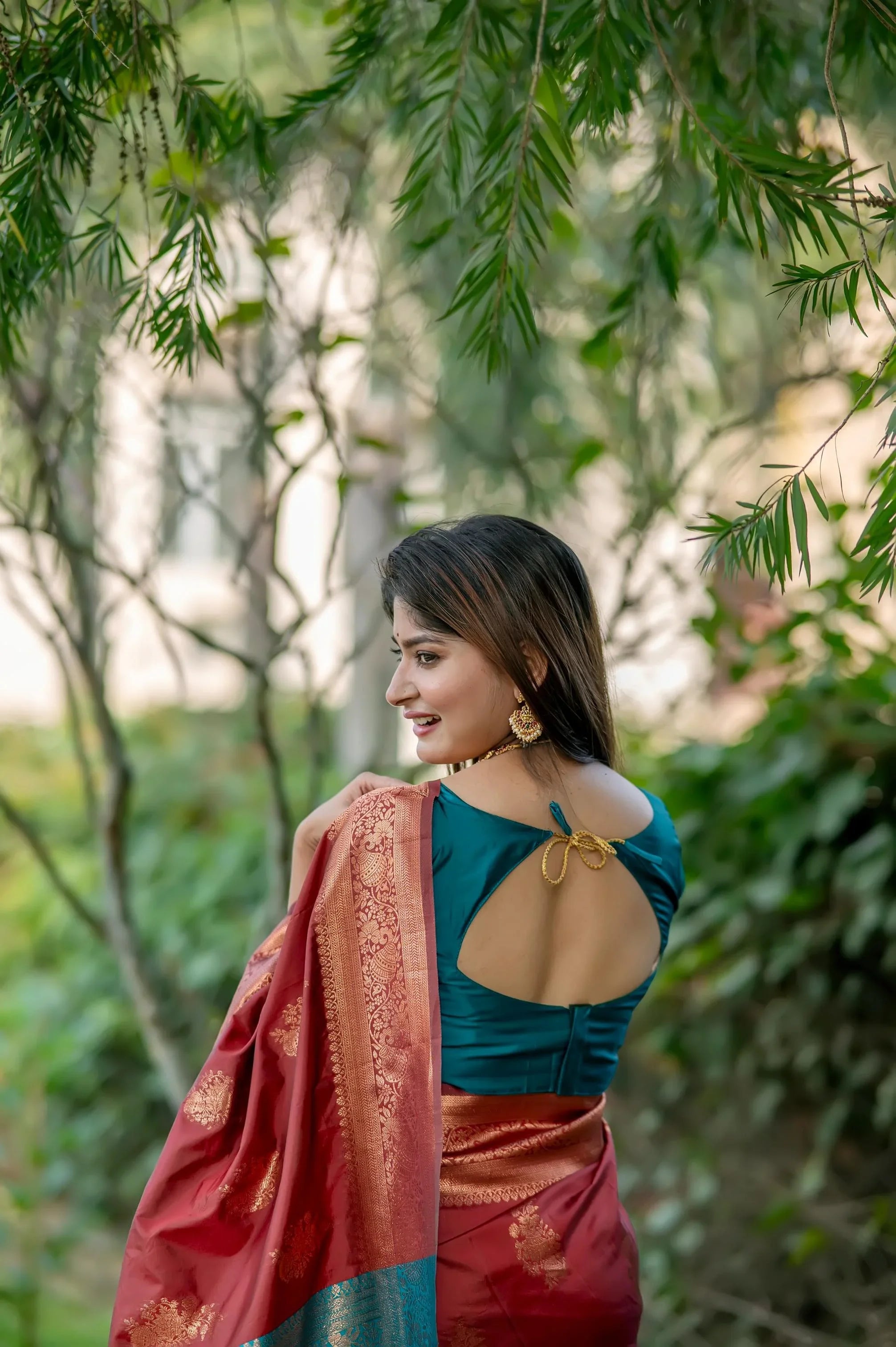 Brown saree with zari work and contrasting teal blouse