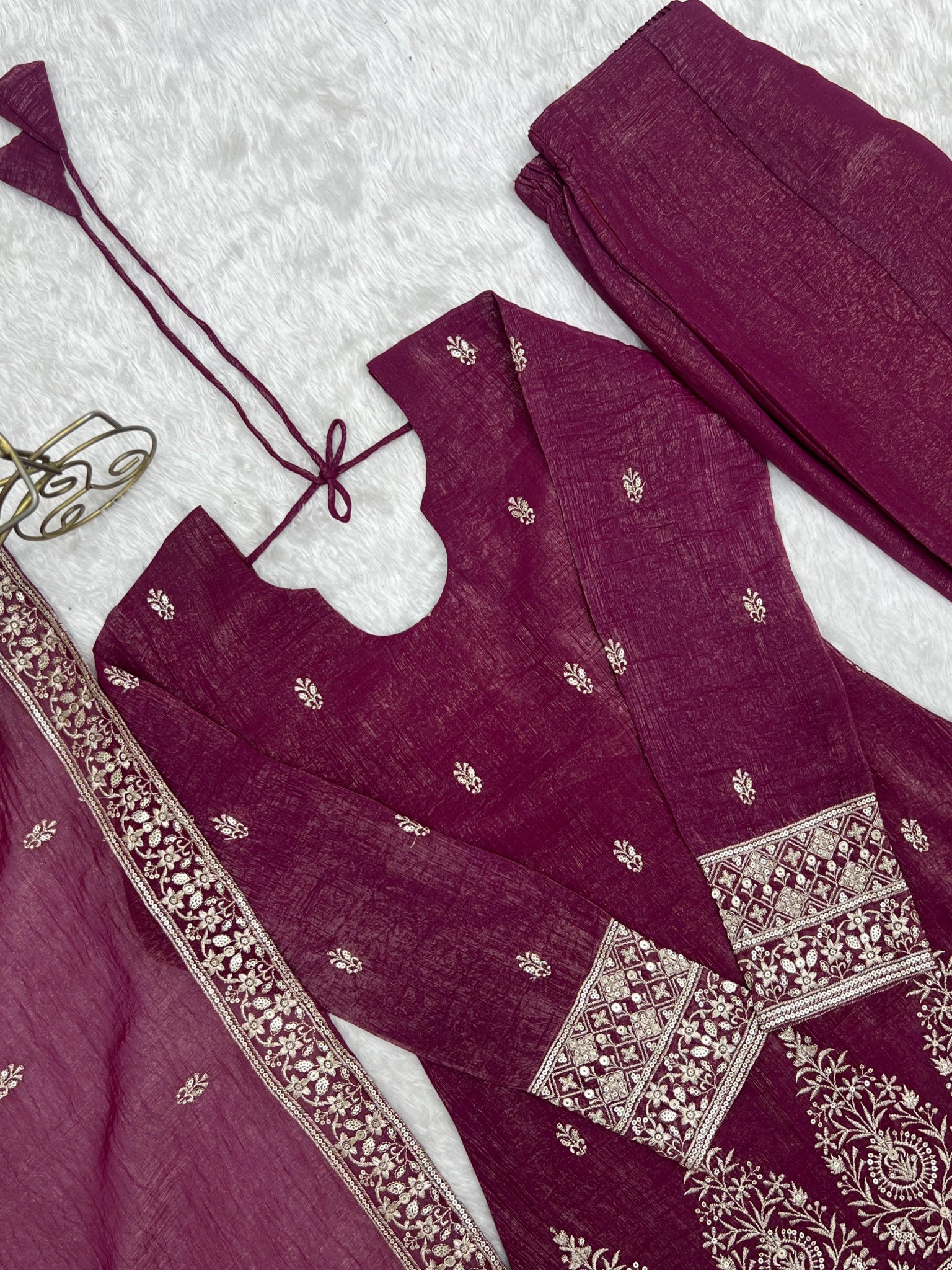 Burgundy suit flat lay - cuff embroidery detail