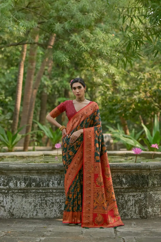 Dark green fabric with intricate zari work