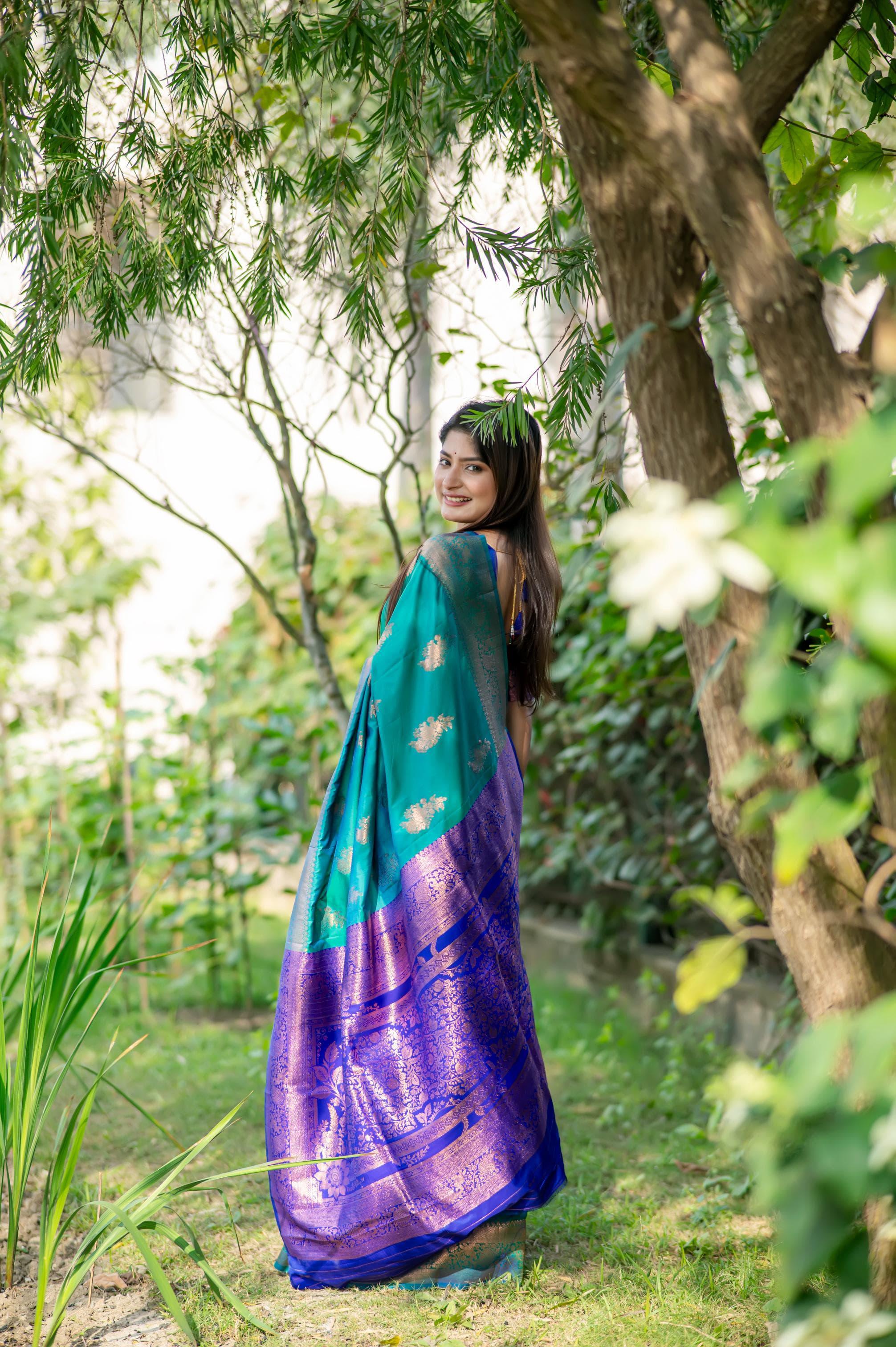 Deep teal saree with zari work and contrasting purple border
