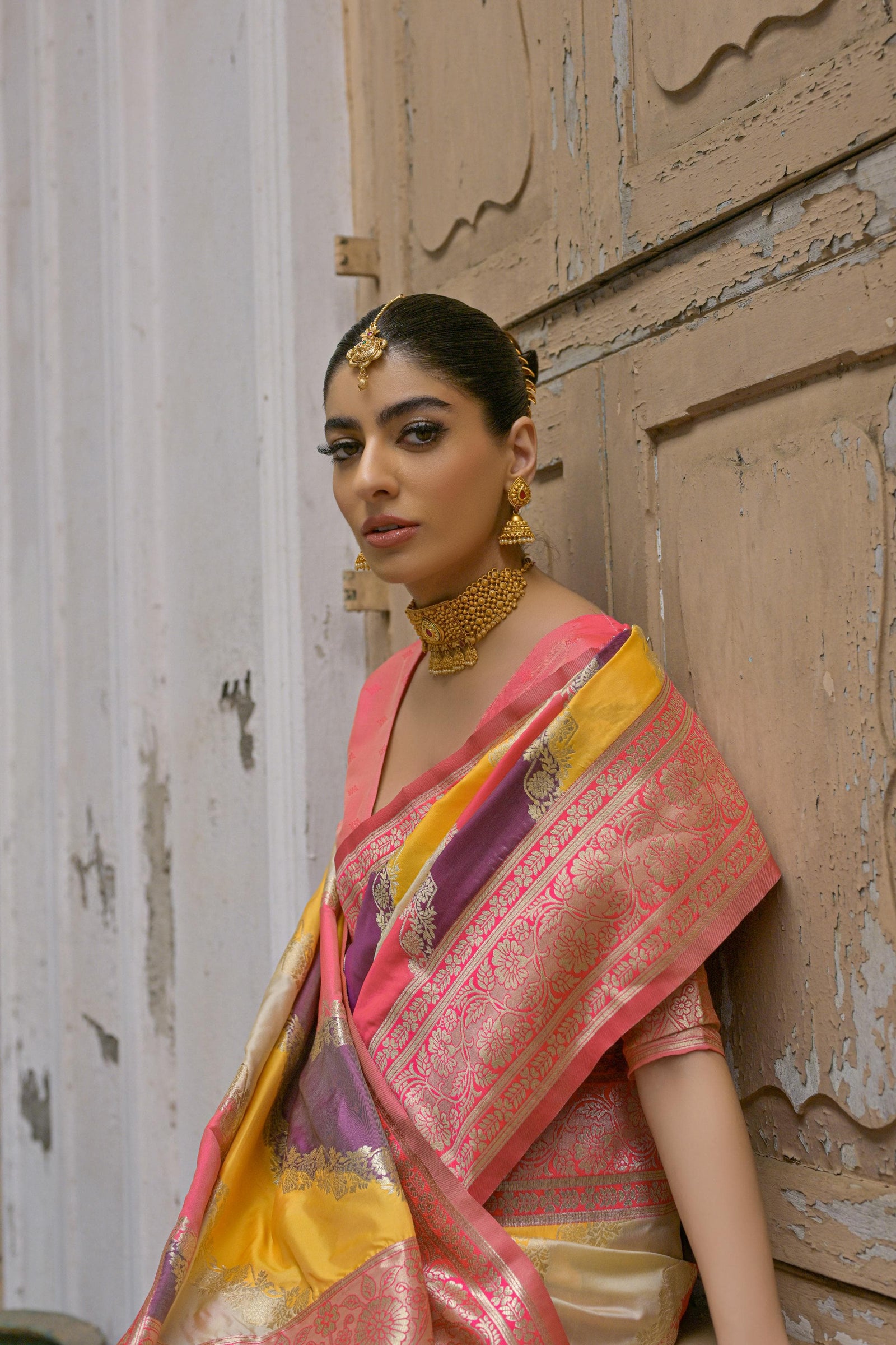 Woman wearing tulip pink floral printed saree standing outdoors in elegant traditional Indian