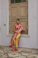 Woman wearing tulip pink floral printed saree standing outdoors in elegant traditional