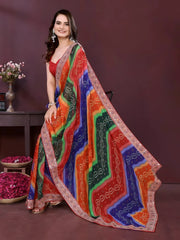 Woman wearing a colorful saree with a patterned design on a dark background