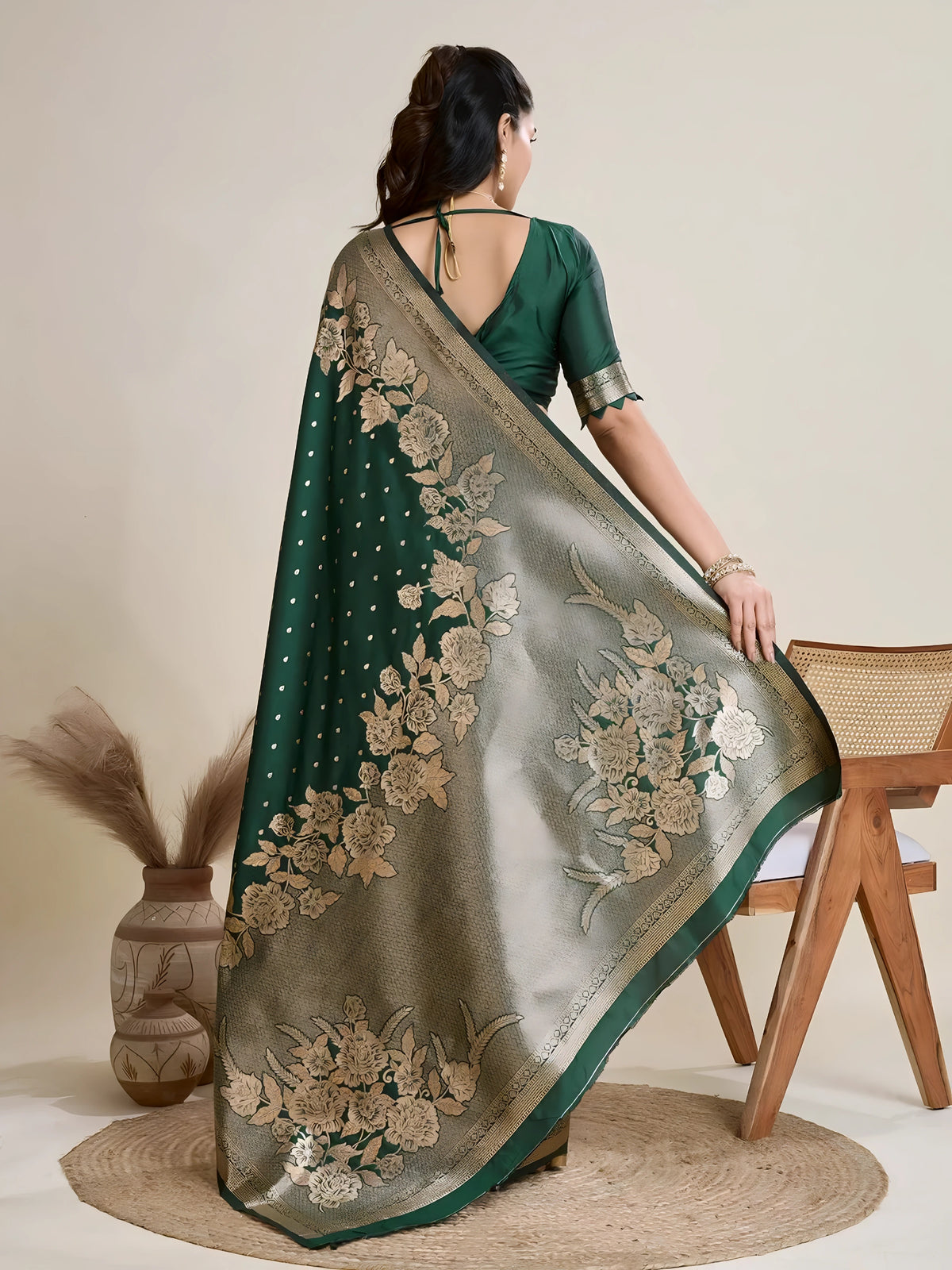 A woman models a luxurious Dark Green Soft Kanjivaram Silk Saree. The saree features striking large floral and scattered motifs woven in metallic antique gold Zari on the body and wide pallu. She wears a matching long-sleeve green blouse and accessorizes with a heavy gold Kundan choker necklace and earrings.