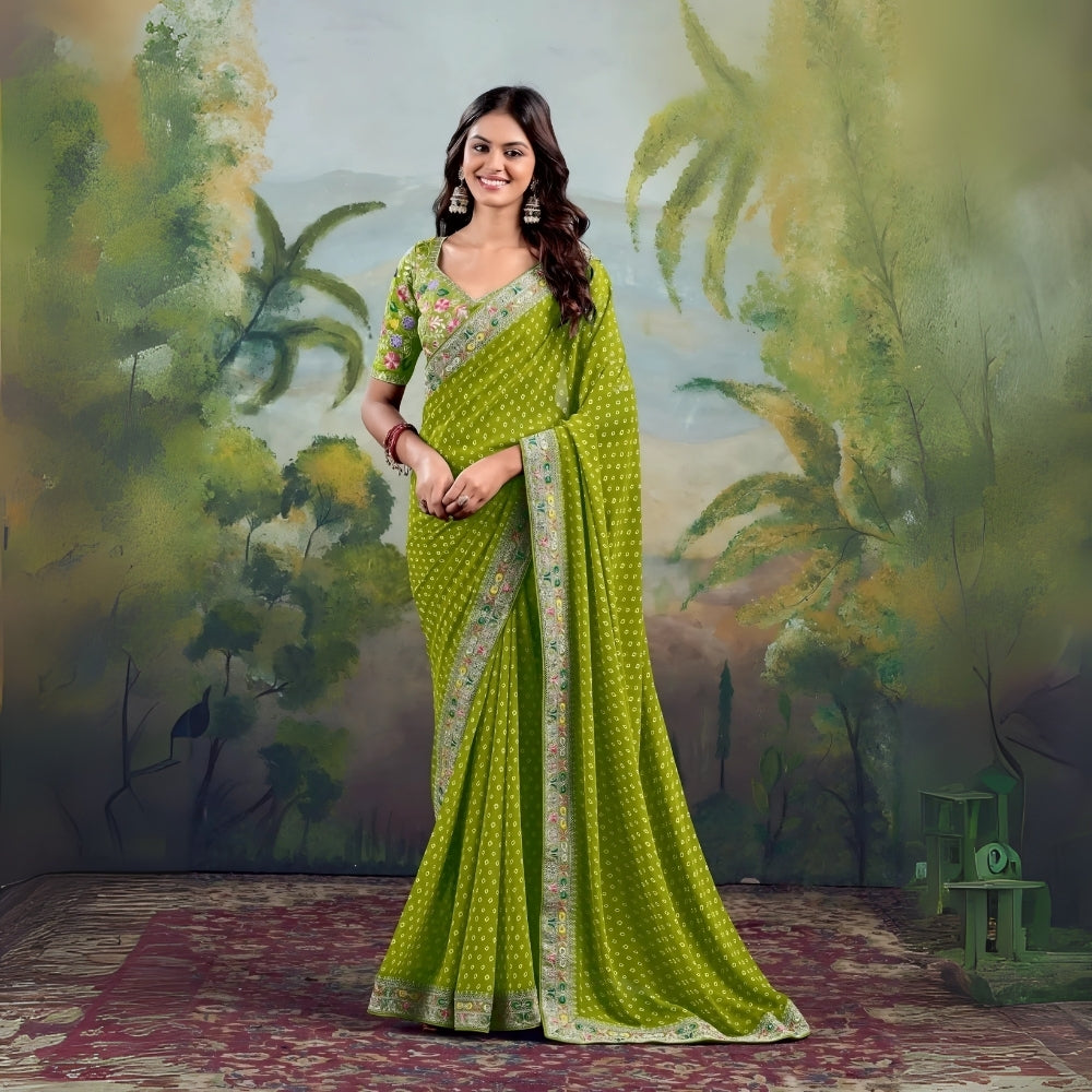 Woman in green saree with floral border and matching blouse, studio backdrop