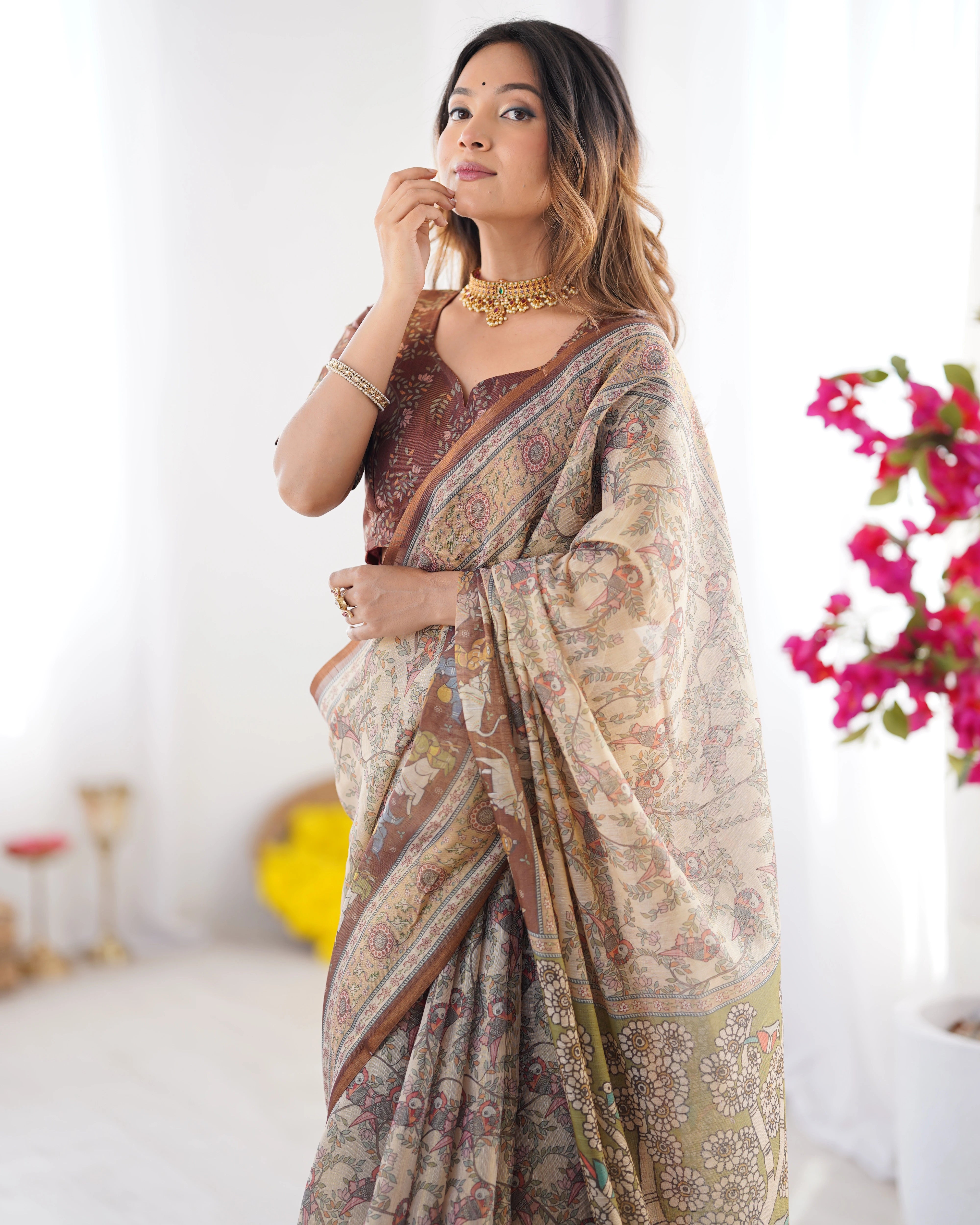 Woman wearing a patterned saree with a blurred background