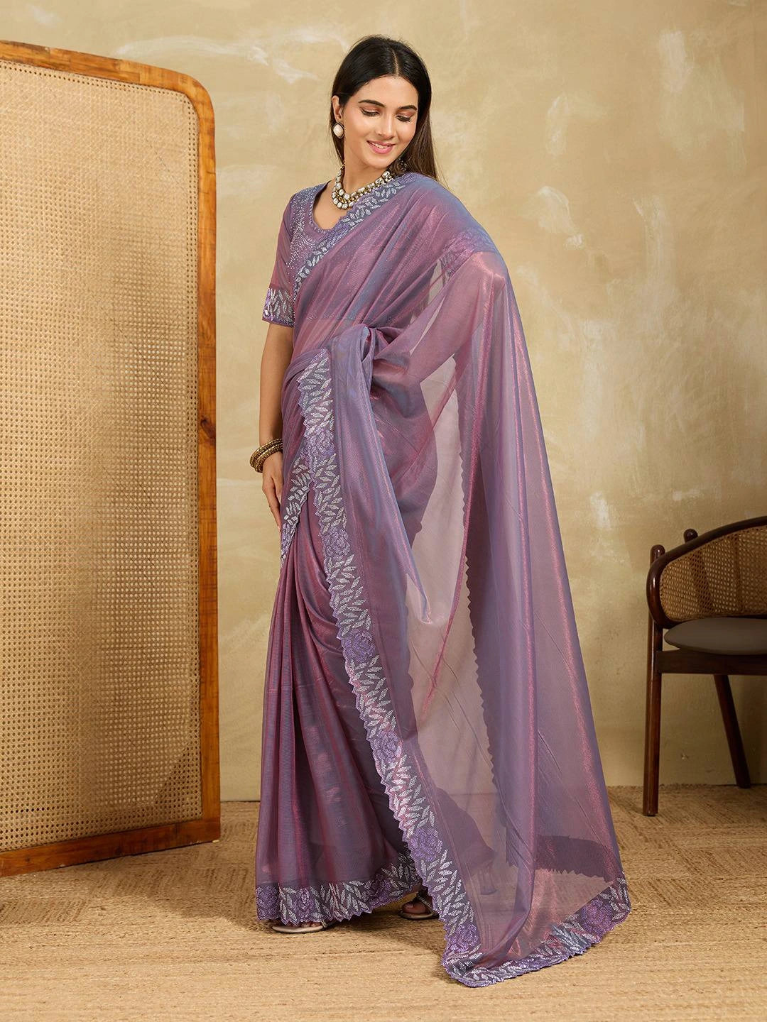 Model showcasing the Lavender Swarovski Work Fendy Soft Net Saree with elegant draping and embellishments.