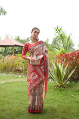 Light beige saree with Patola print in a garden outdoors