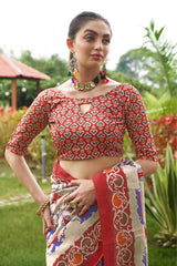 Close up of light beige saree with Patola print and red border