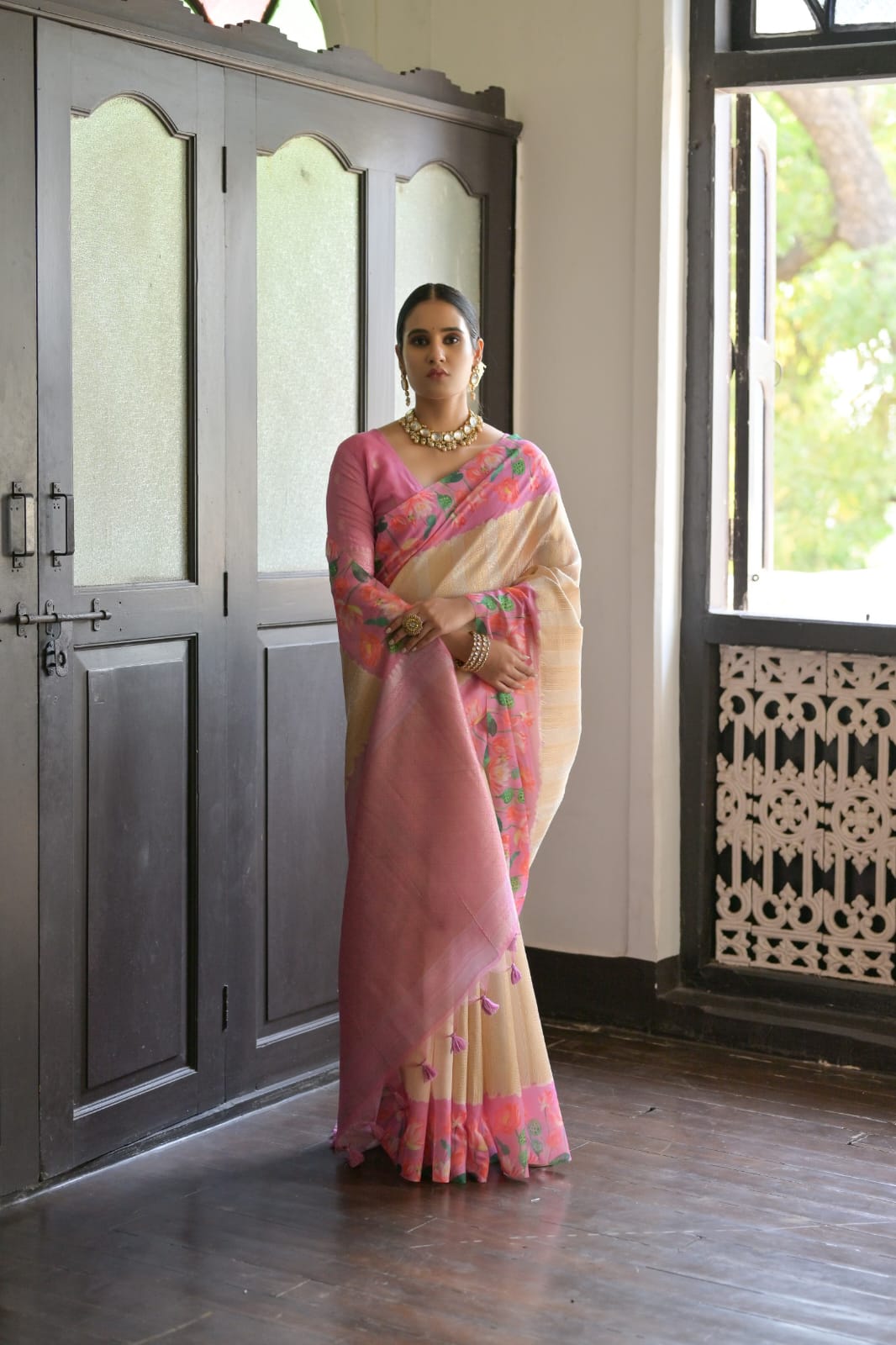 Graceful light pink saree adorned with delicate zari work design
