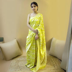 Woman in a lime jacquard work saree with gold border standing indoors in a vibrant room with arched decor and vintage furniture accents