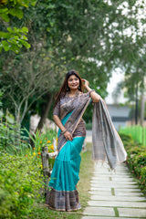 Teal Madhubani print saree with intricate traditional Indian artwork and ethnic detailing