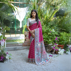 A woman models a vibrant Dark Pink Tussar Silk Saree with small scattered prints. The pallu features a wide, elaborate panel with intricate Madhubani-style folk art prints in white, red, pink, and green. She wears a cream/gold embellished blouse and a gold Kundan choker necklace.