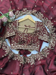 Maroon saree flat lay with embroidered blouse piece