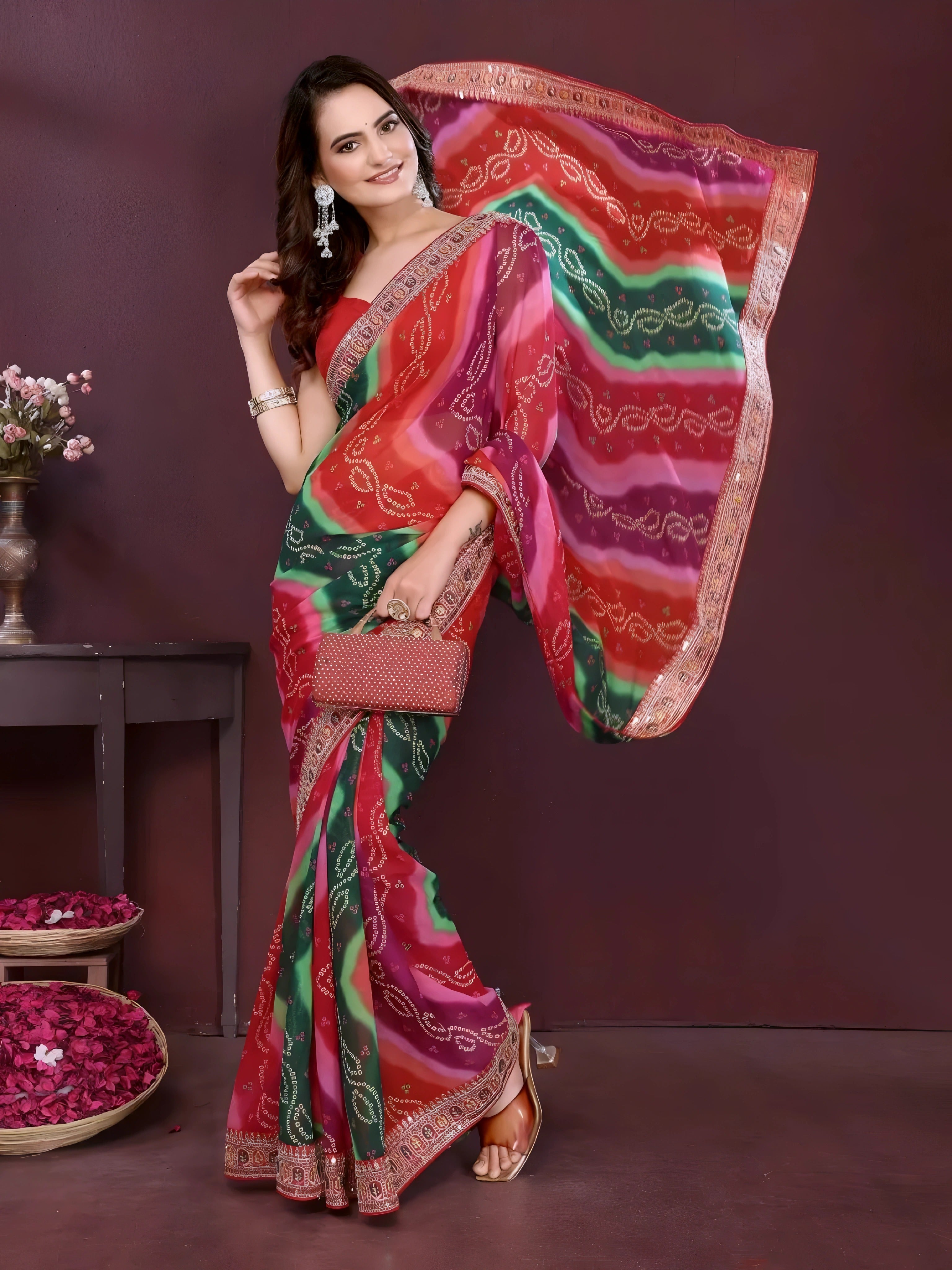 Woman wearing a colorful saree with a red and green pattern against a dark background