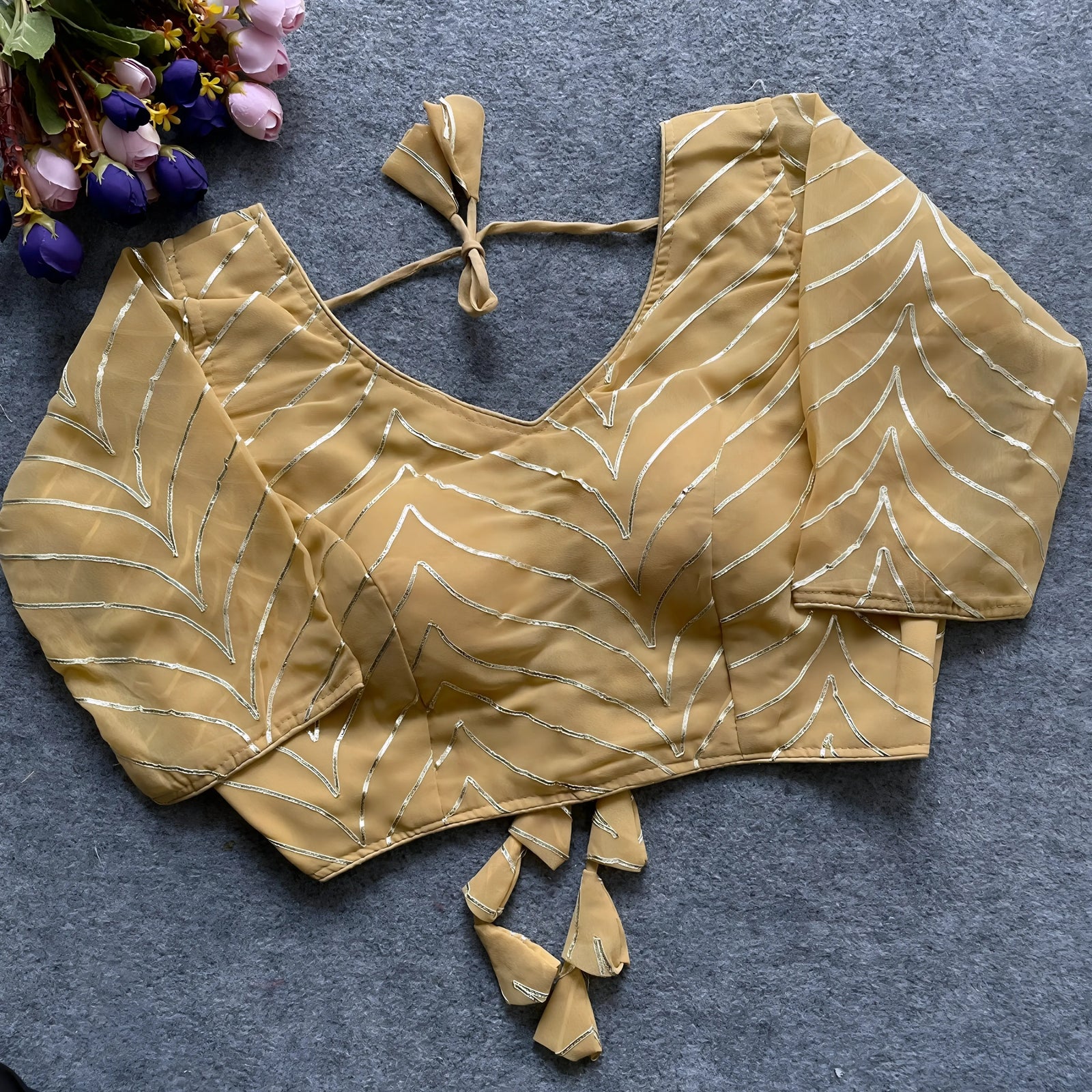 Mustard gold women’s blouse with silver geometric embroidery, elbow-length sleeves, and tie-back detail