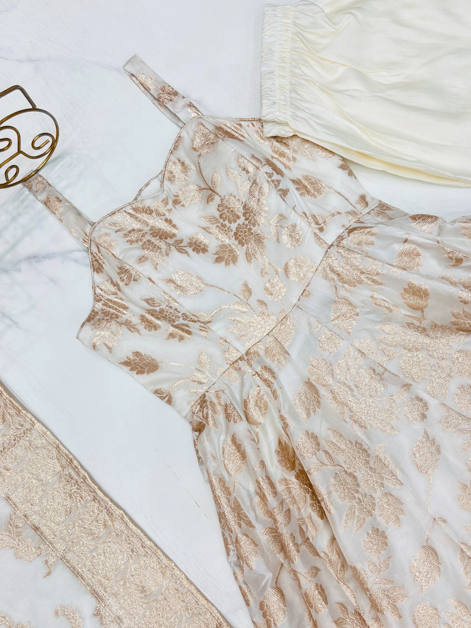 Close-up of Off White Banarasi jacquard weave and sweetheart neckline flat lay
