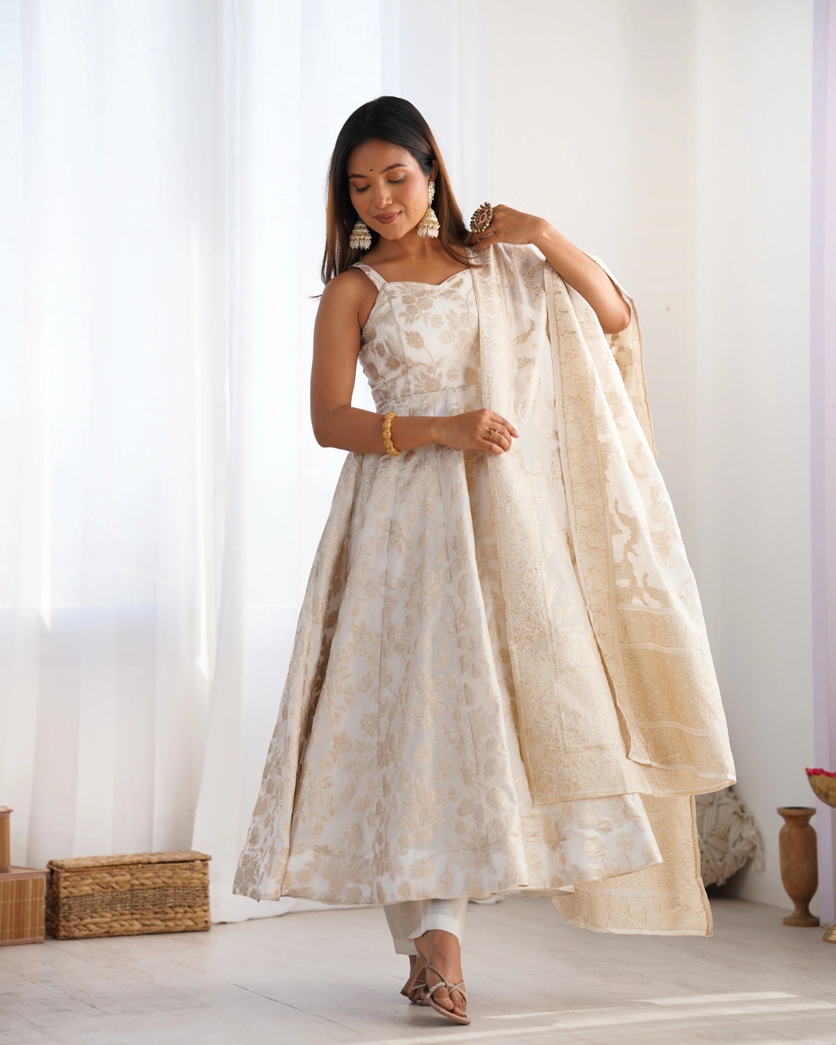Off White Dola silk blend Anarkali suit with dupatta draped on arm