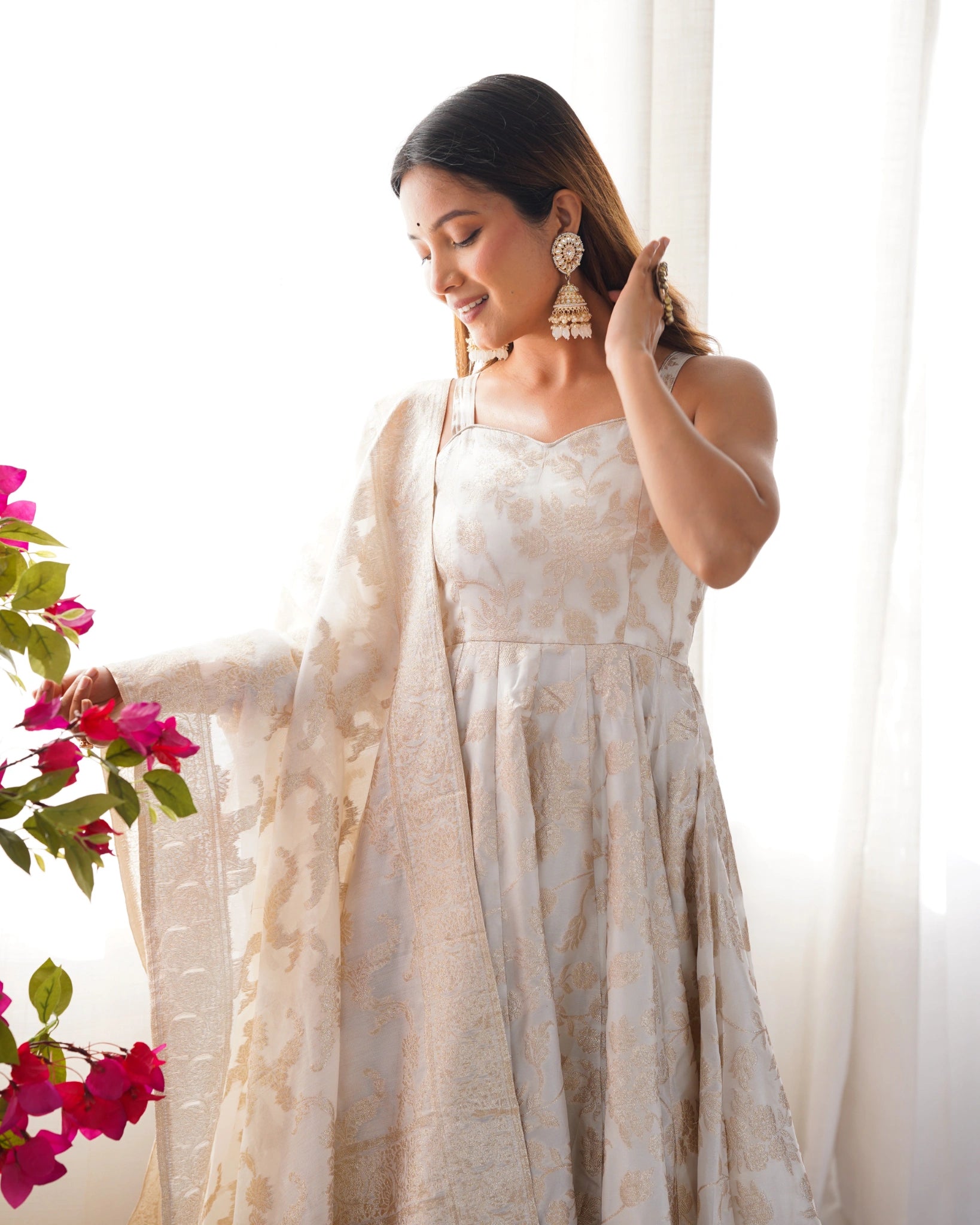 Off White sleeveless Anarkali suit with Banarasi dupatta, close portrait