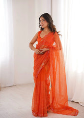 Orange sequins embroidered thread work soft net saree – front drape on model