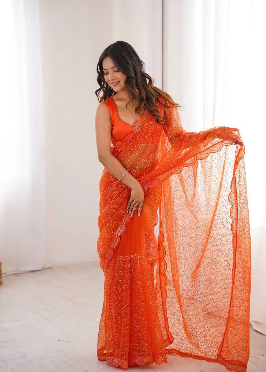 Orange net saree with sequin work – side view on model