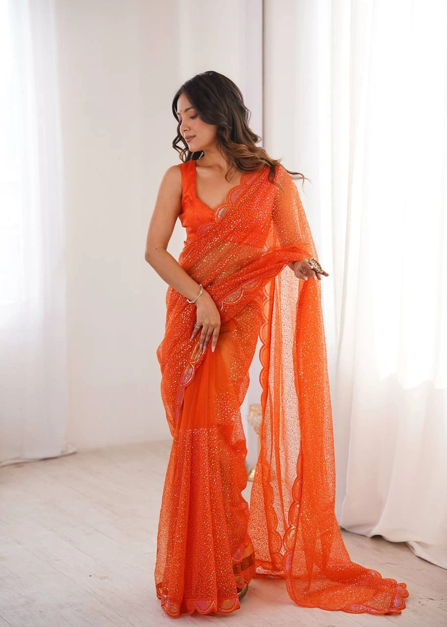 Orange party wear sequins saree – pleats and pallu on model