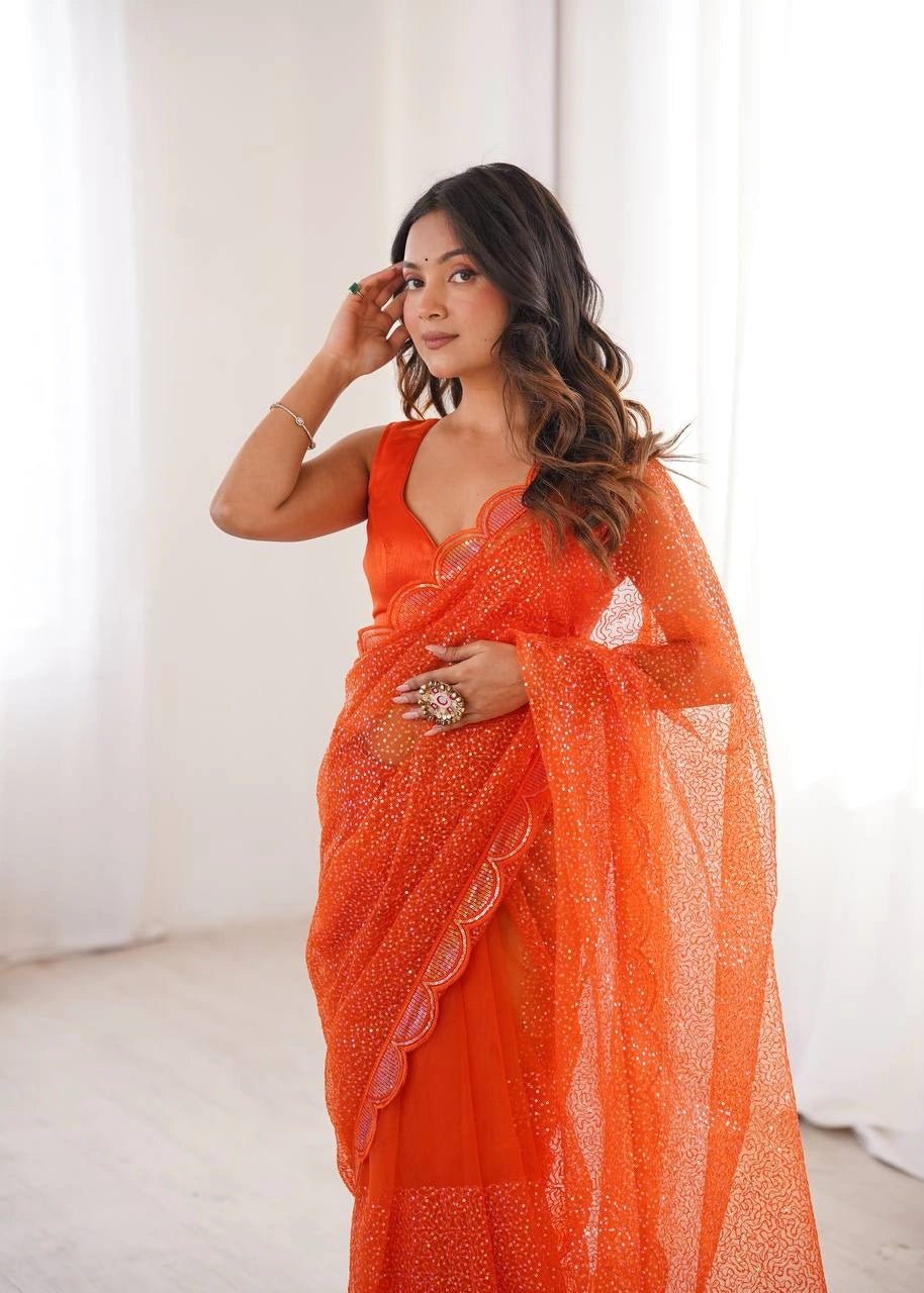 Orange wedding wear net saree – draped look on model