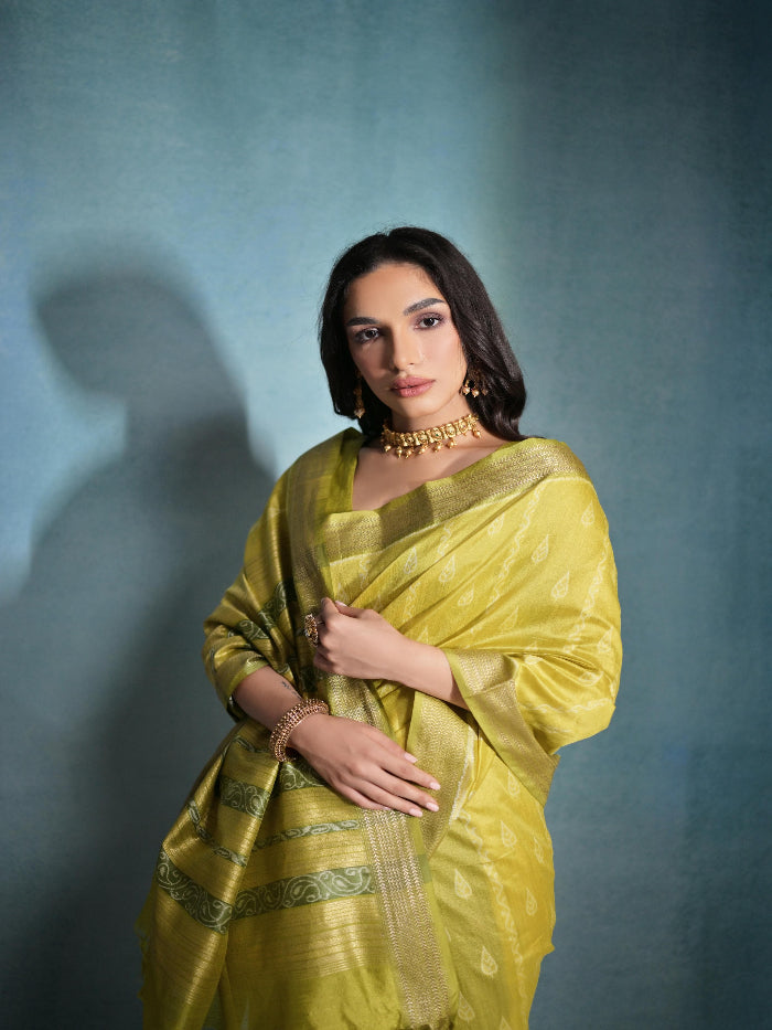 Pale yellow saree featuring intricate ikkat and zari weaving, showcasing traditional handloom textile craftsmanship