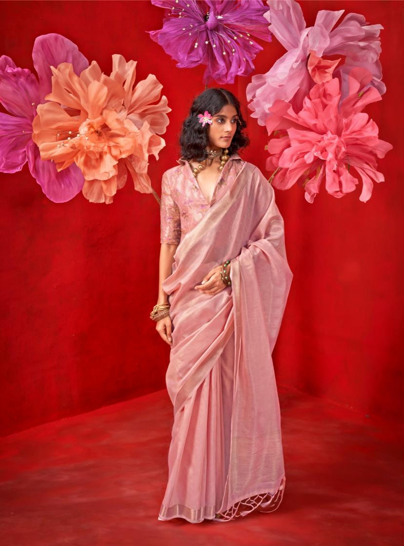 Pastel pink saree with intricate zari work, model wearing traditional attire by Rajtex Kronis, showcasing handloom weaving, product