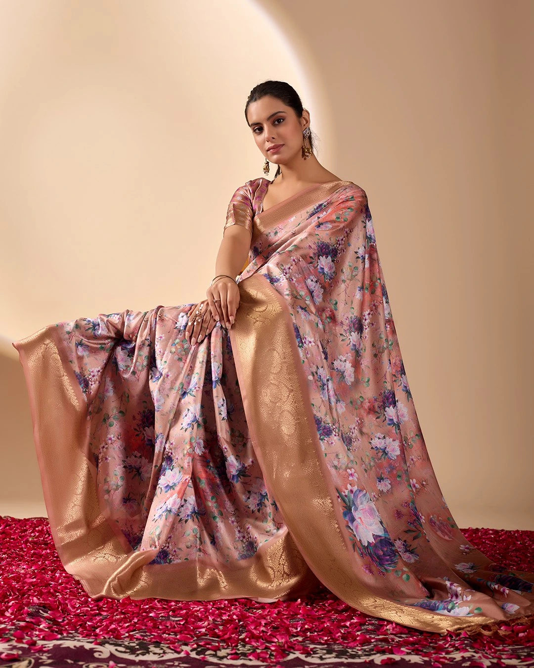 Soft pink lichi silk saree featuring a vibrant floral digital print, an elegant gold zari woven border, and tassel details by Kalyanja.