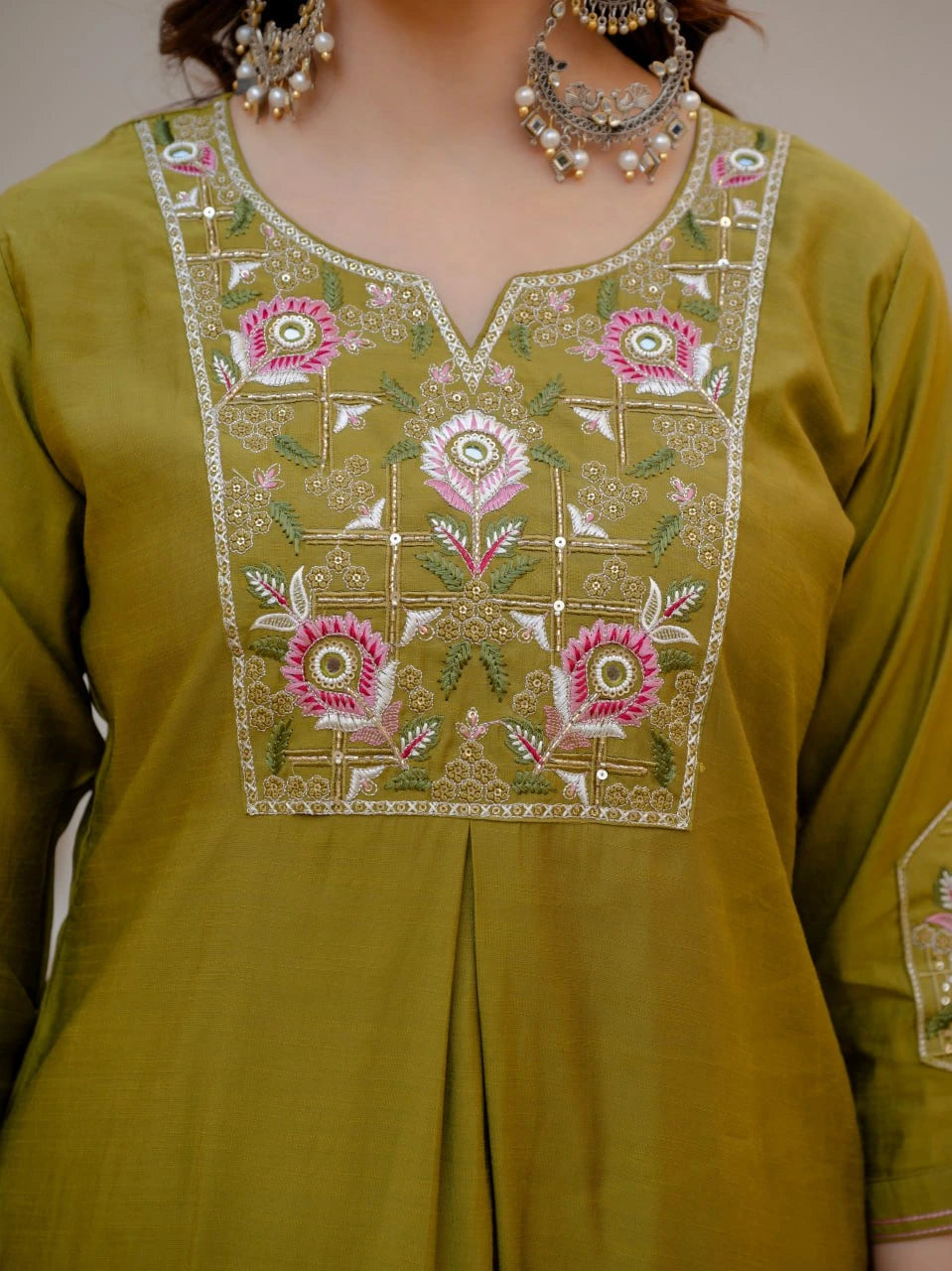 Green embroidered kurta with floral patterns on a plain background