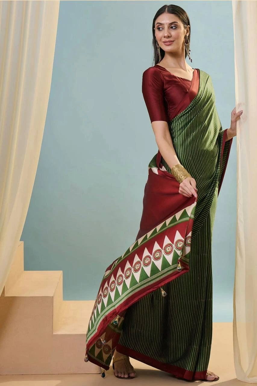 Woman wearing a traditional saree with a geometric pattern against a light blue background
