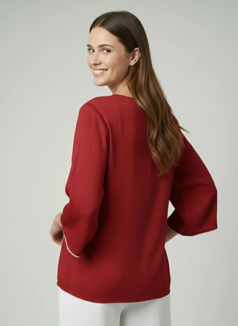 Woman wearing a red blouse with a plain background