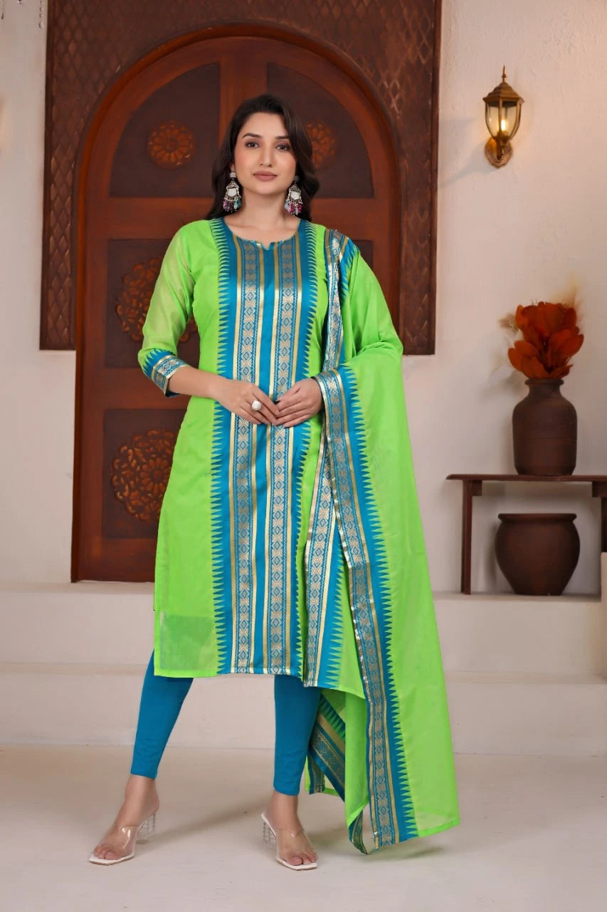 Woman wearing a green and blue traditional outfit with a decorative background
