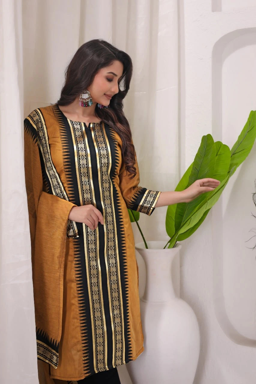 Woman wearing a mustard yellow and black patterned dress against a white curtain background