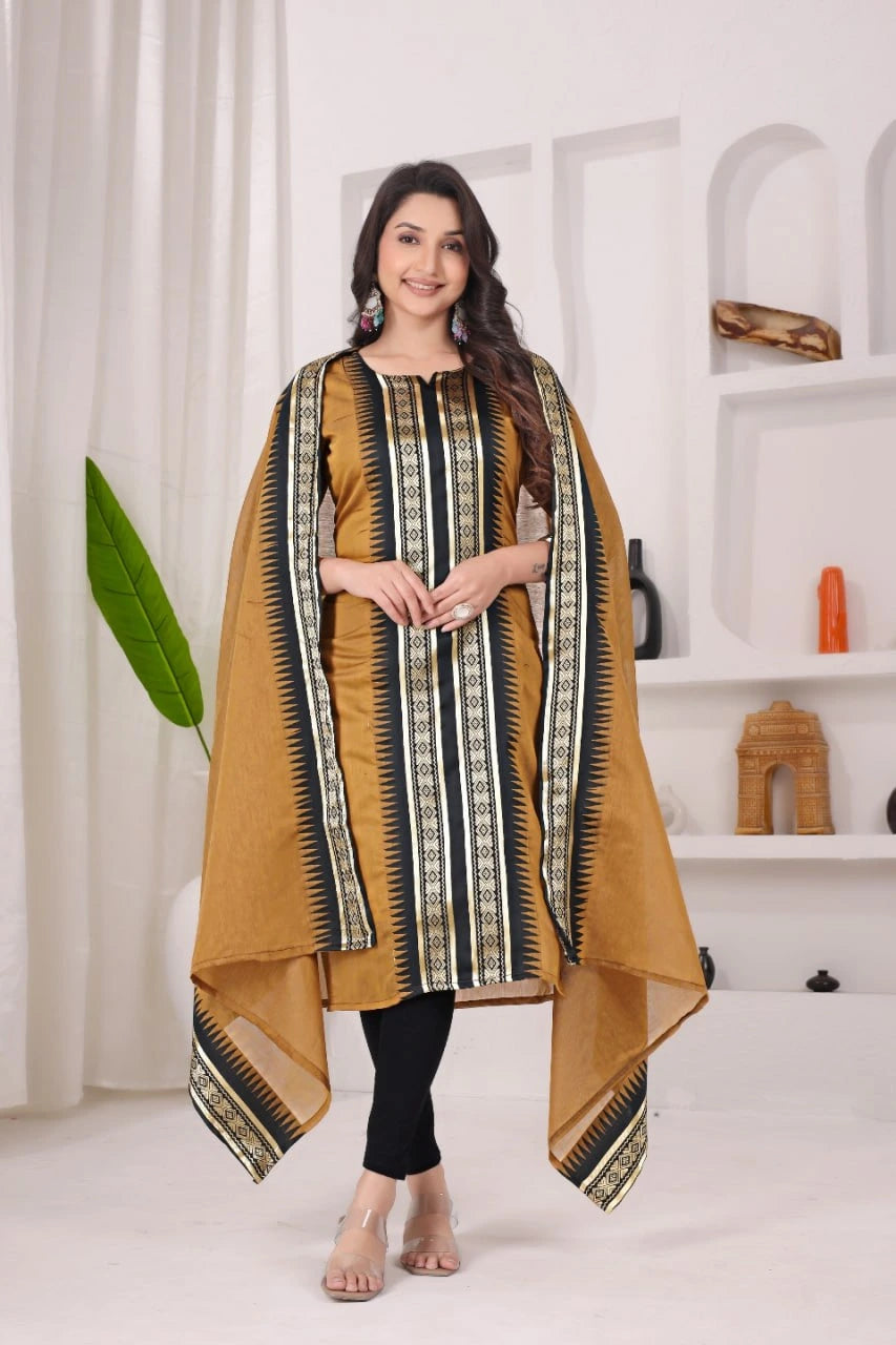 Woman wearing a mustard yellow and black traditional outfit with a patterned dupatta in a minimalistic setting.
