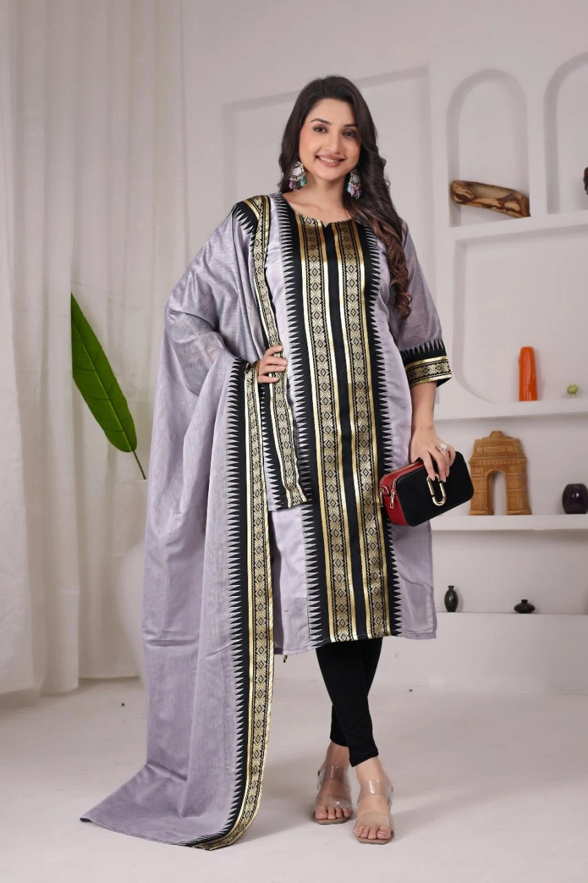 Woman wearing a traditional outfit with a long scarf in a minimalistic setting