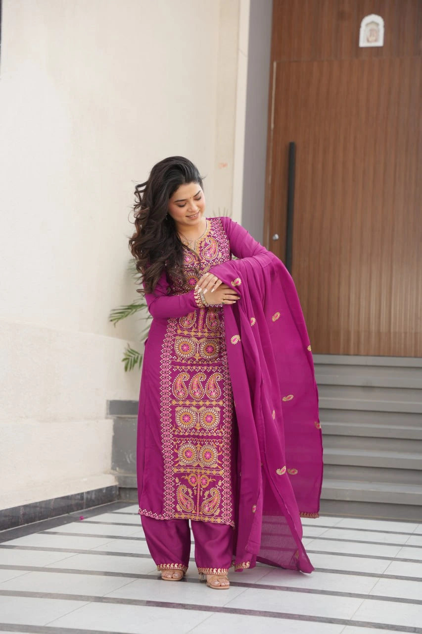 Woman in a traditional pink embroidered outfit holding a dupatta.