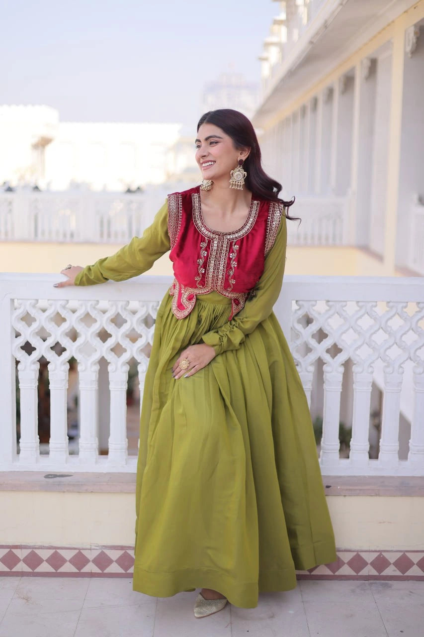 Woman in a green and red traditional outfit standing on a balcony.