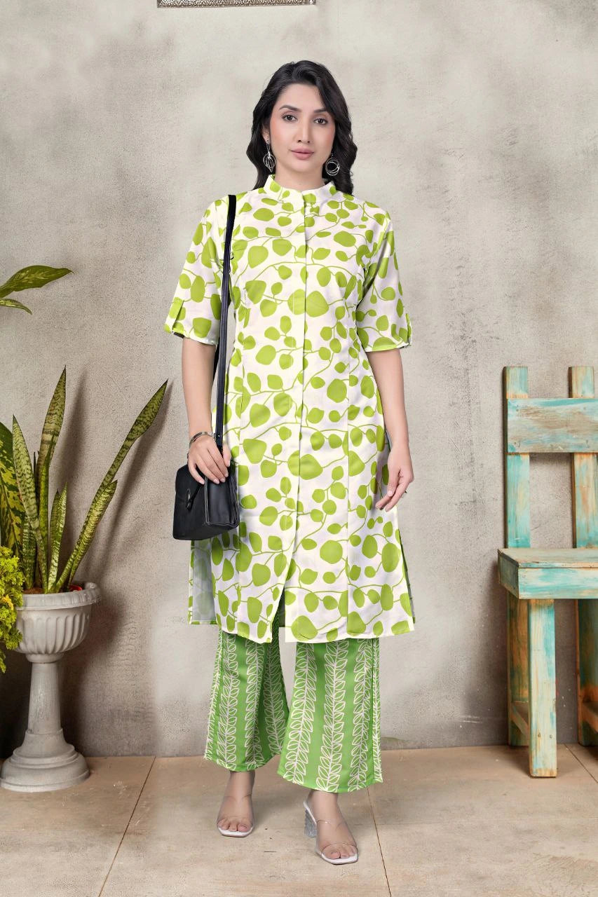 Woman wearing a green and white patterned outfit standing against a neutral background.