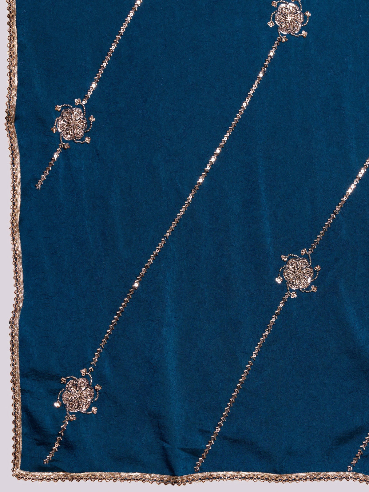 Blue fabric with gold embroidery on a white background